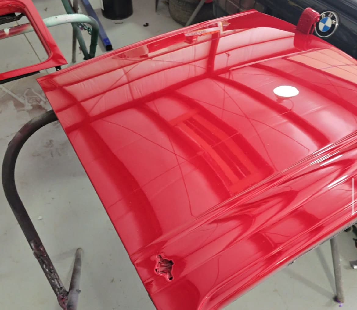 Red car hood freshly painted