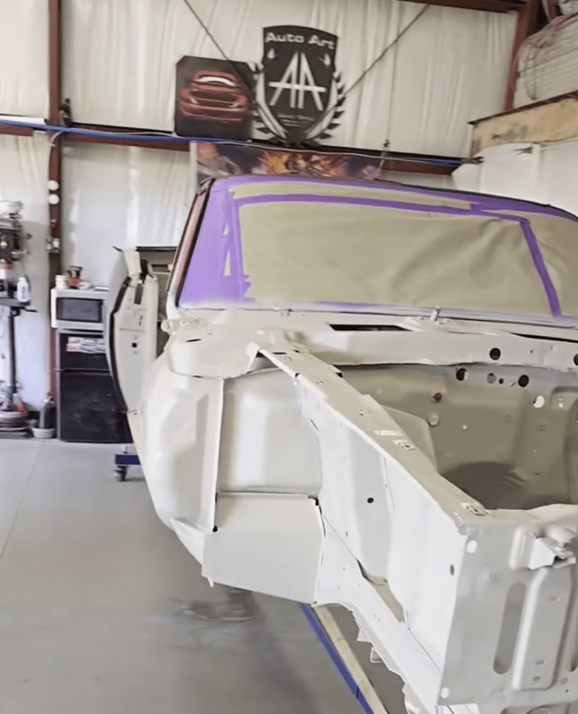 Car taken apart in restoration process, showing primer on car before it is to be painted