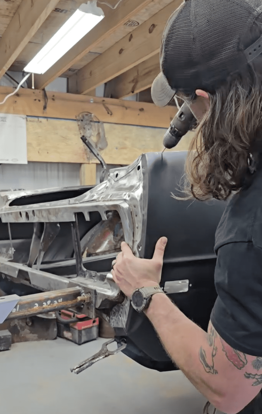Cecil Henry fitting parts on a car