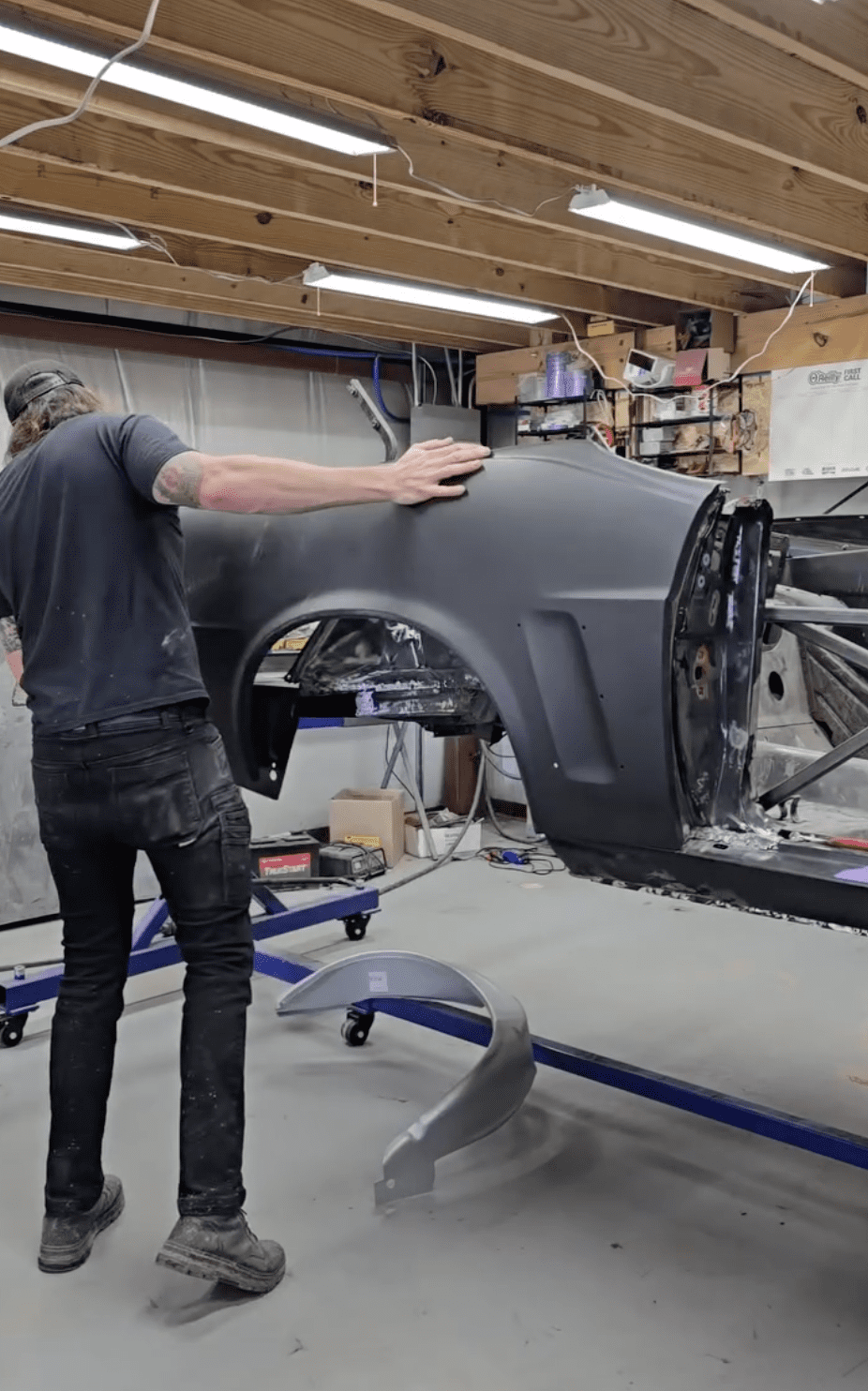 Cecil Henry fitting parts on a black car