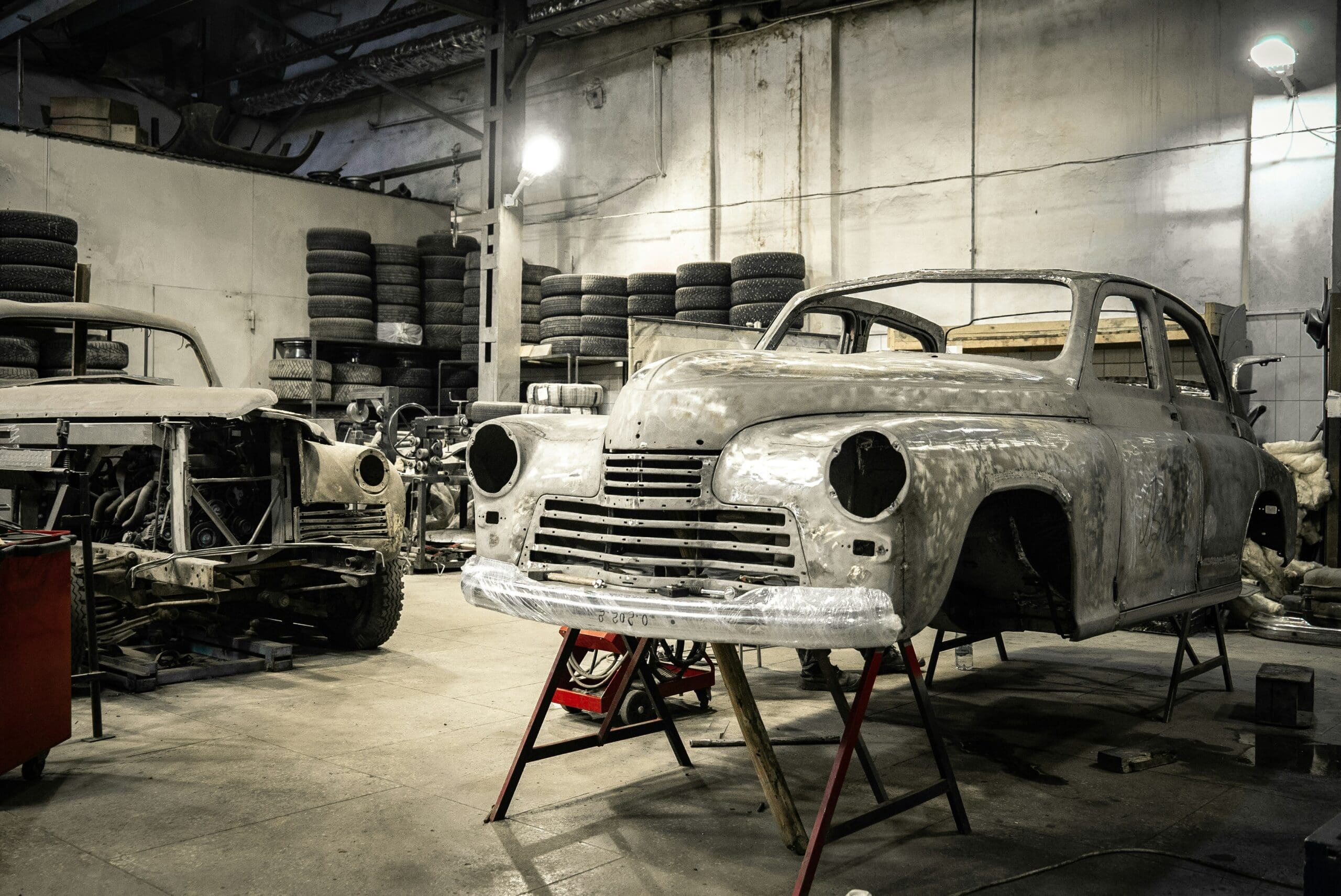 Classic car being restored in a body shop